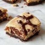 A layered cheesecake cake with rich chocolate and creamy peanut butter frosting, topped with chocolate shavings and peanut butter drizzle, plated elegantly on a white cake stand against a rustic wooden background, with a fork beside it revealing its moist, smooth texture.